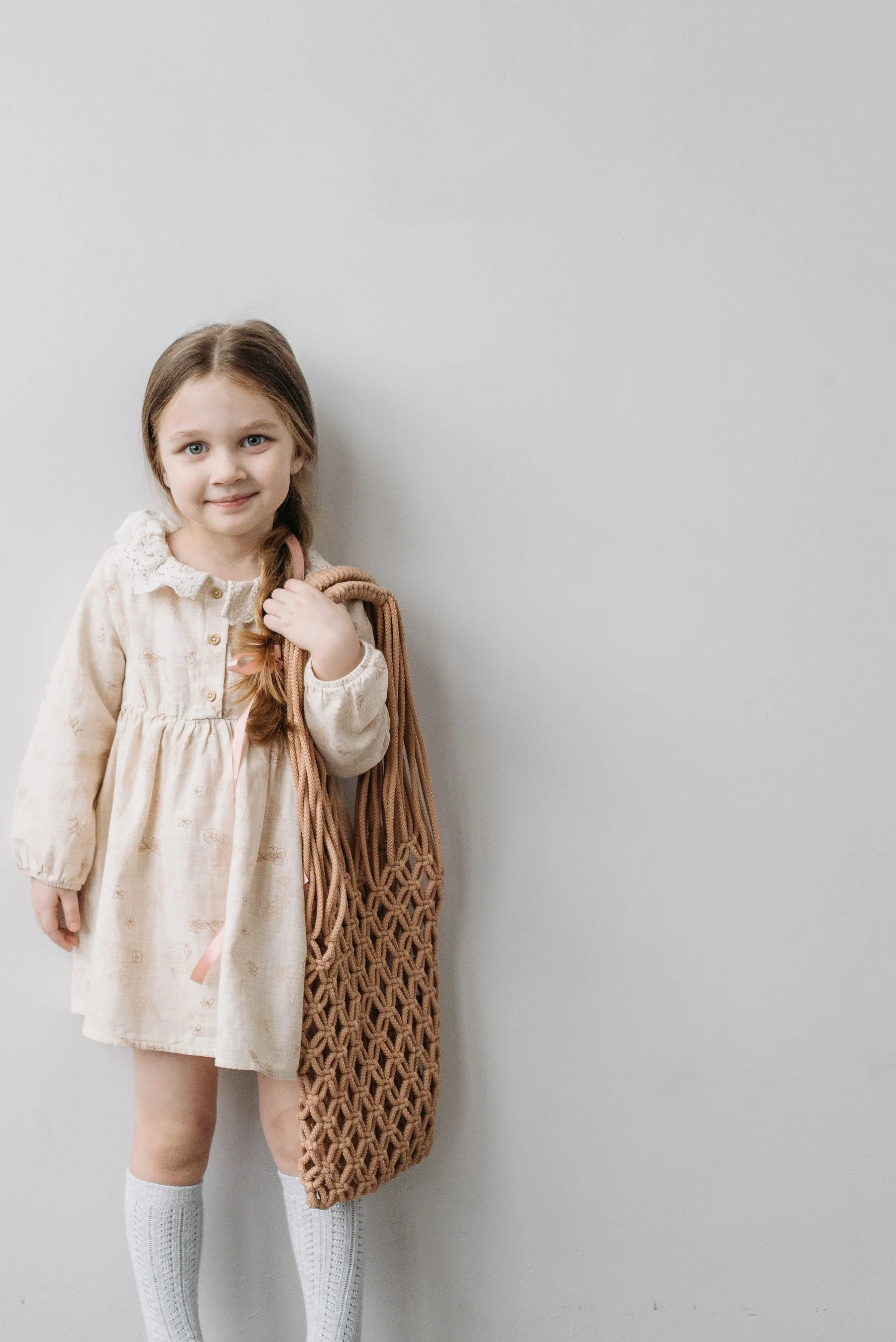 Young girl wearing a modern neutral kids outfit